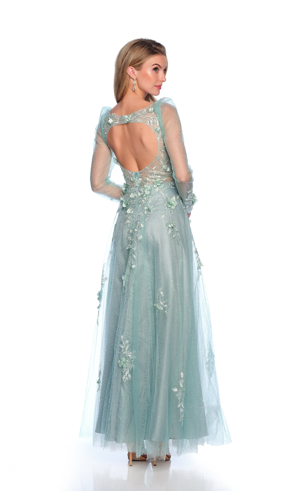 Woman models the Dave & Johnny 12127 Formal Dress with Sleeves—a light blue, lace-embroidered gown featuring floral details, sheer sleeves, and an open back, posed against a white background.